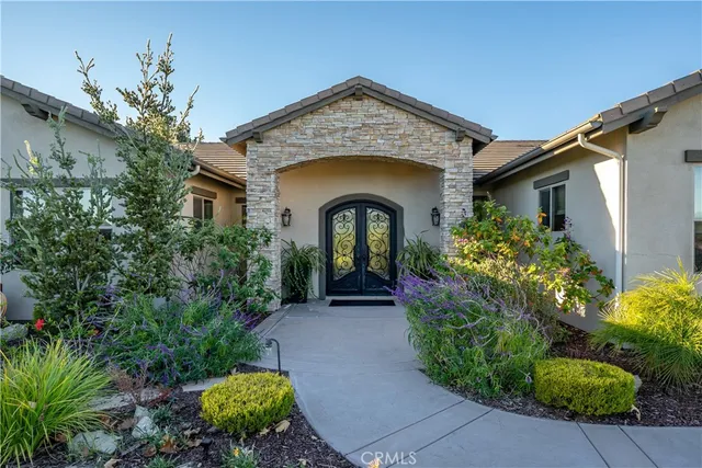 a front view of a house with garden