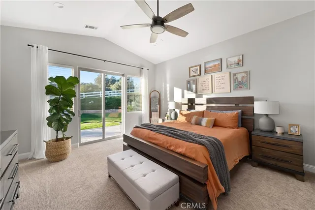 a living room with furniture a rug and a ceiling fan
