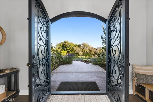 a kitchen with stainless steel appliances granite countertop a stove a sink dishwasher a refrigerator and a oven with wooden floor