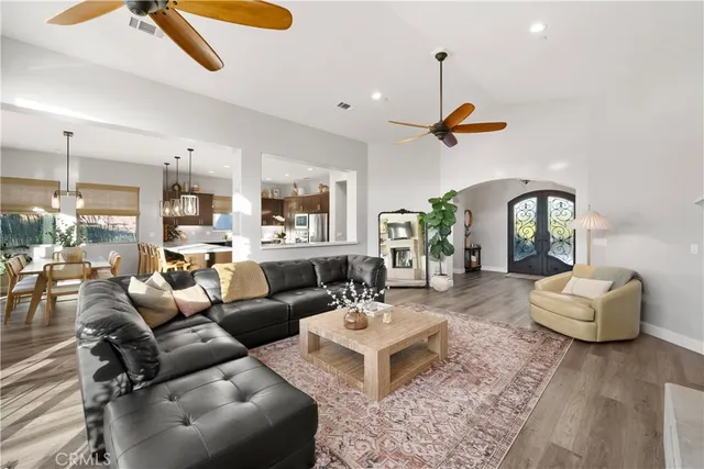 a kitchen with stainless steel appliances granite countertop a stove a sink and a wooden floors