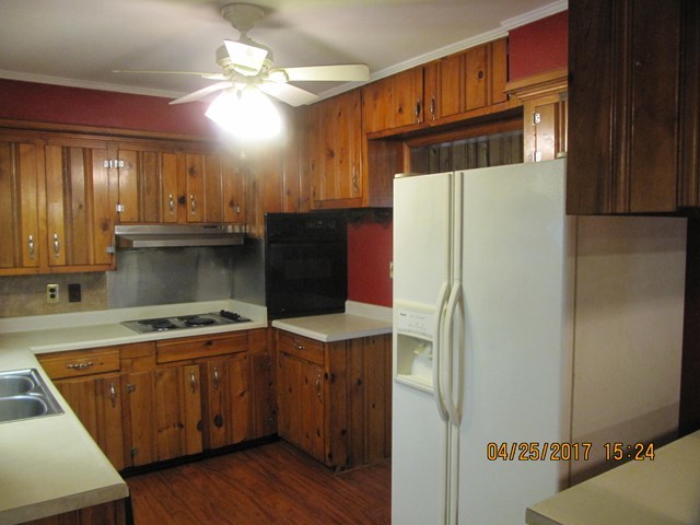1062 Wriley Road McIntyre, GA 31054 - Photo 2 of 28 a kitchen with a refrigerator sink and cabinets