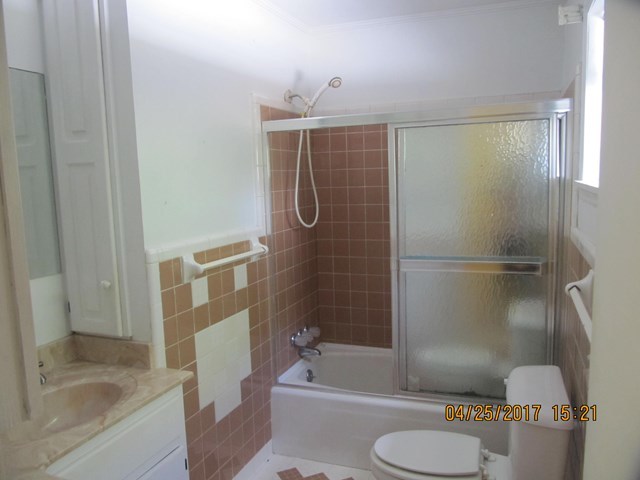 1062 Wriley Road McIntyre, GA 31054 - Photo 11 of 28 a bathroom with a granite countertop bathtub shower sink vanity and toilet
