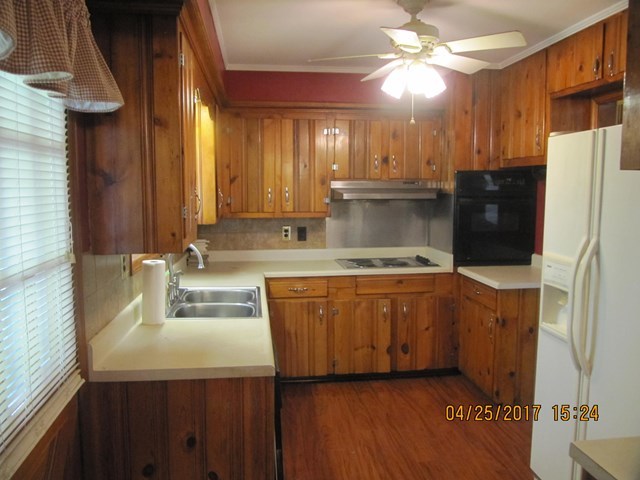 1062 Wriley Road McIntyre, GA 31054 - Photo 3 of 28 a kitchen with stainless steel appliances granite countertop a sink a refrigerator and a stove