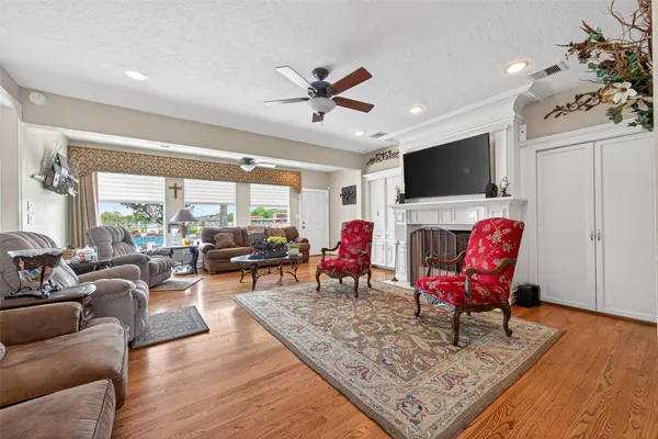 a living room with furniture a flat screen tv and a rug