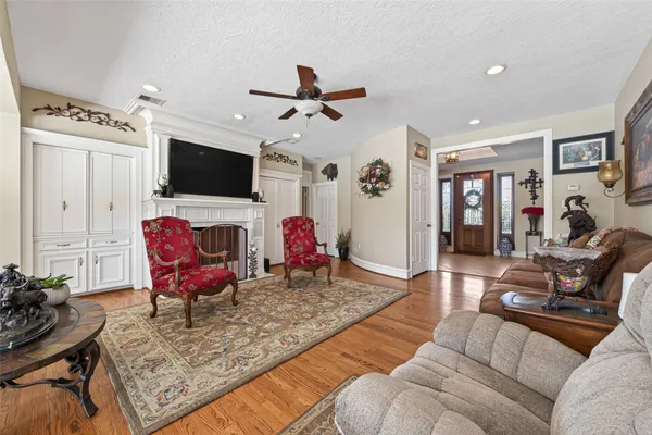 a living room with furniture a flat screen tv and a window
