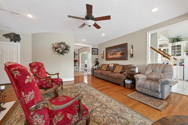 a living room with furniture kitchen view and a rug