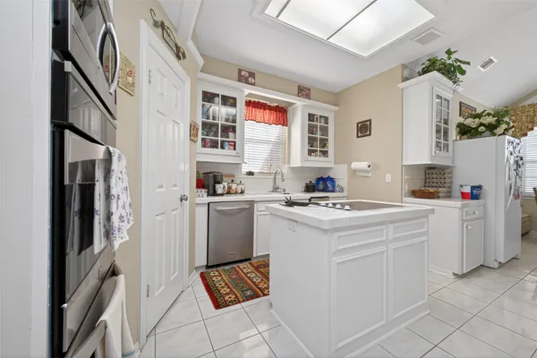 a kitchen with cabinets appliances and a counter top space