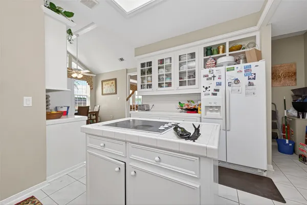 a kitchen with stainless steel appliances granite countertop a sink and a refrigerator