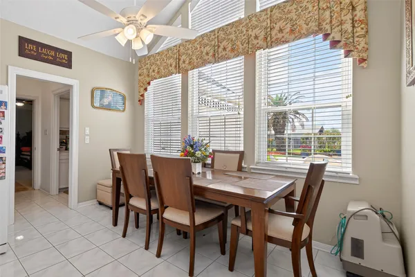 a view of a dining room with furniture and window