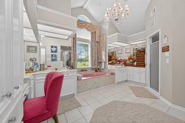 a large white kitchen with a large window