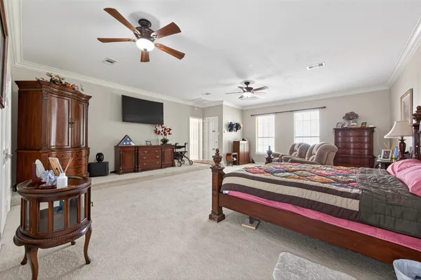 a living room with furniture a chandelier and a flat screen tv