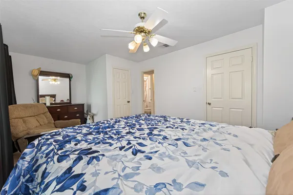 a bedroom with a bed and a chandelier