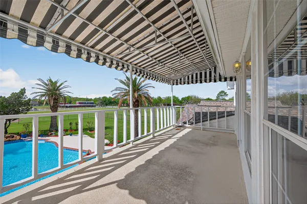 a front view of a house with swimming pool garden and patio