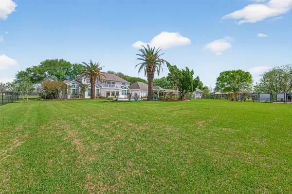 a view of a house with a backyard and a garden