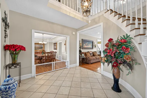a living room with furniture flower potted plant and a large window