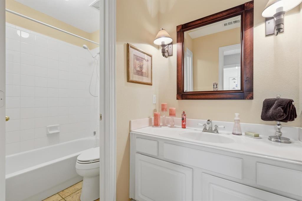 2012 Hayden Lane Corinth, TX 76210 - Photo 34 of 40 a bathroom with a toilet sitting next to a bathroom sink