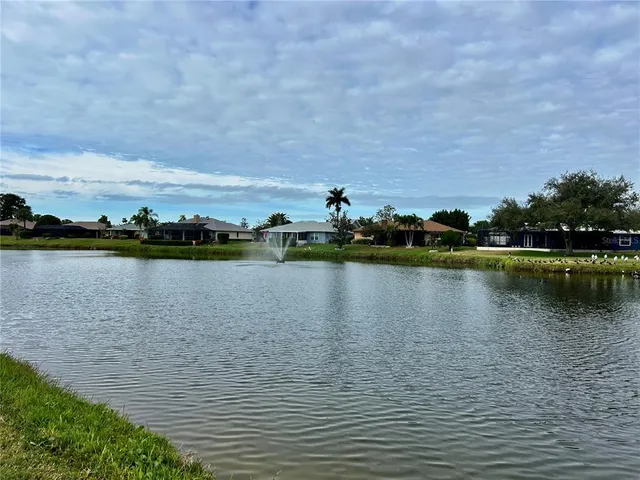 a view of a lake with houses in the back