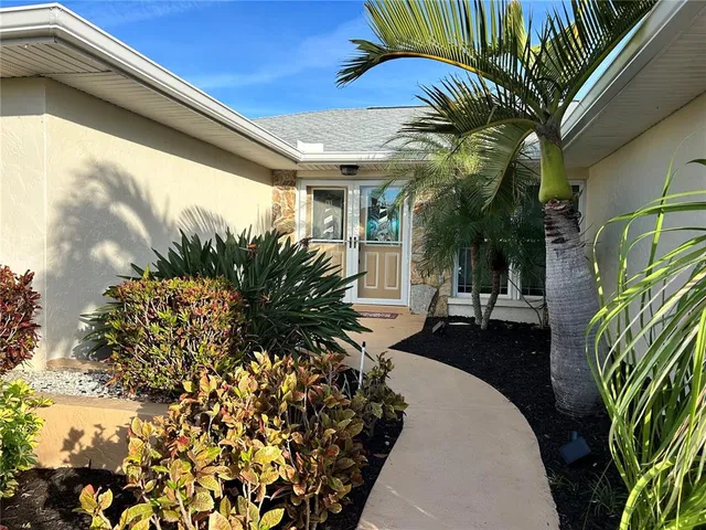 a vase of flowers sitting on a table in front of a building