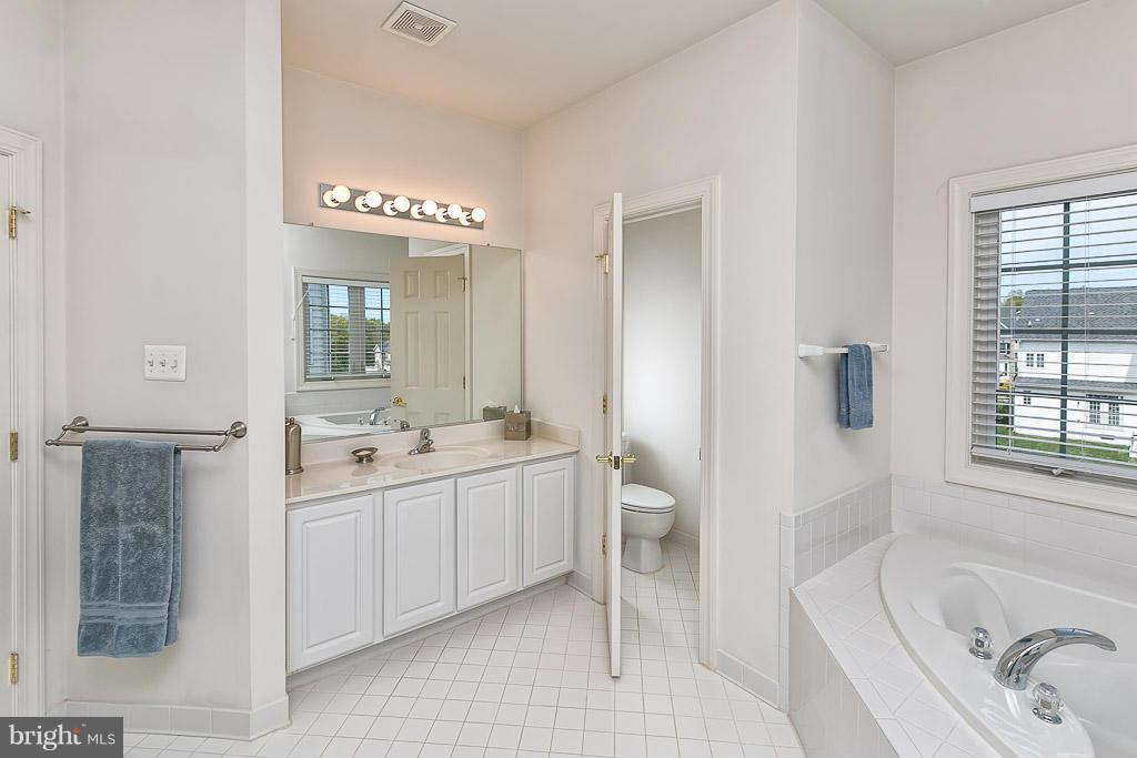 8916 Ricky Trevor Road Perry Hall, MD 21128 - Photo 22 of 30 a bathroom with a tub sink and mirror