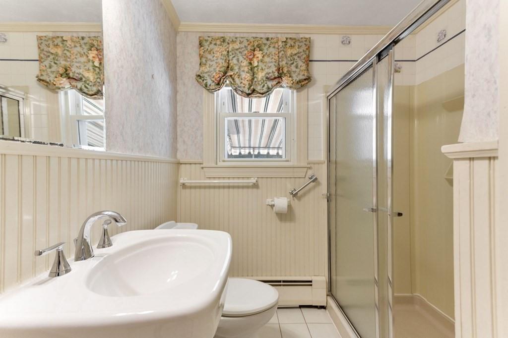 65 Moffatt Road Salem, MA 01970 - Photo 16 of 35 a bathroom with a sink a mirror a window and a shower