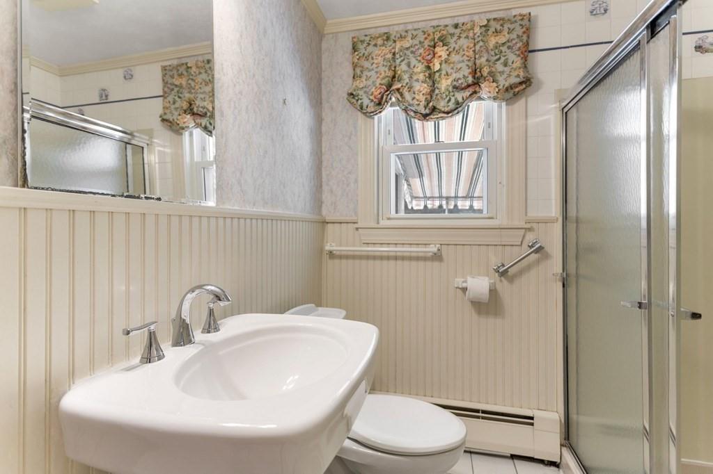 65 Moffatt Road Salem, MA 01970 - Photo 17 of 35 a bathroom with a sink a mirror a toilet and a shower