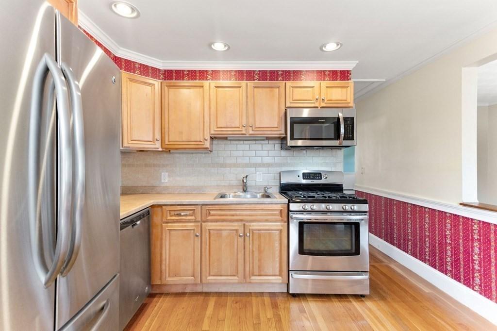 65 Moffatt Road Salem, MA 01970 - Photo 5 of 35 a kitchen with a stove and a microwave