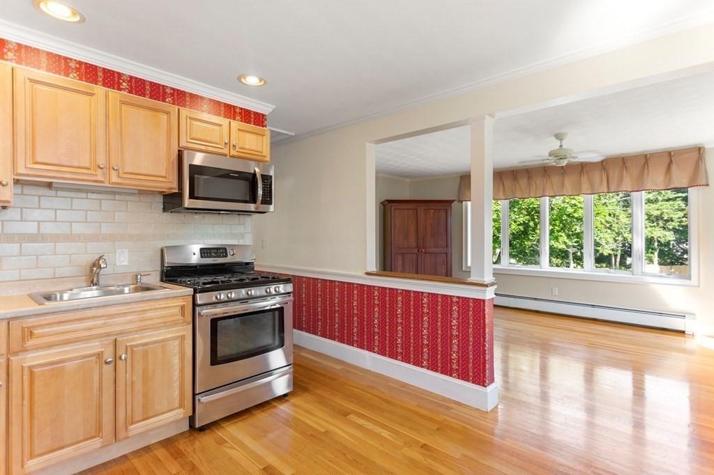 65 Moffatt Road Salem, MA 01970 - Photo 6 of 35 a kitchen with stainless steel appliances a stove sink microwave and cabinets