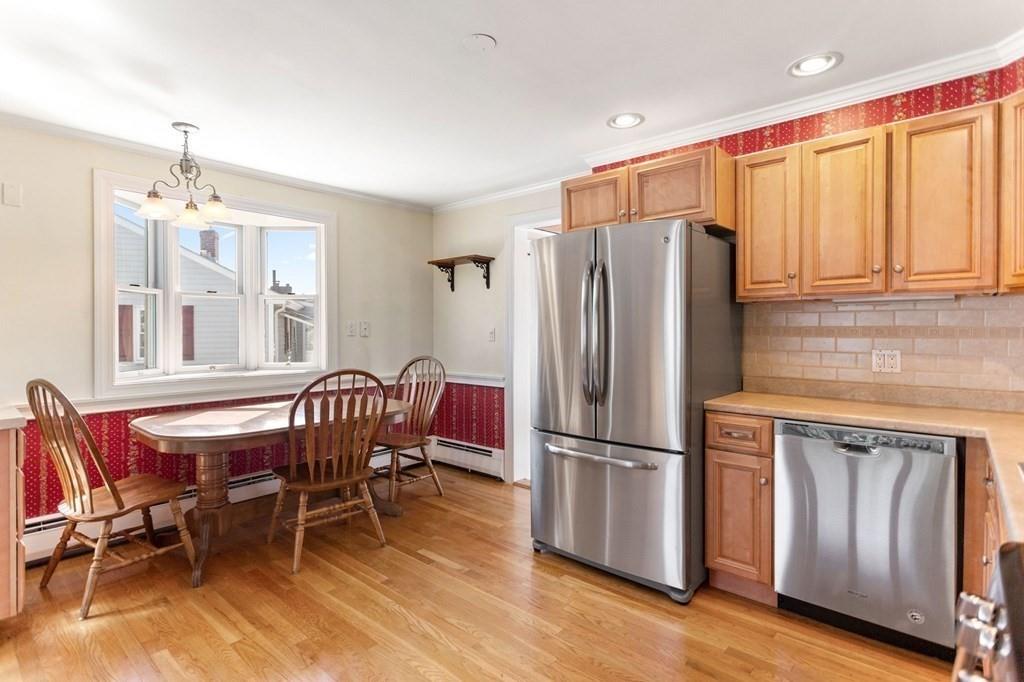 65 Moffatt Road Salem, MA 01970 - Photo 7 of 35 a kitchen with stainless steel appliances granite countertop a refrigerator and wooden cabinets