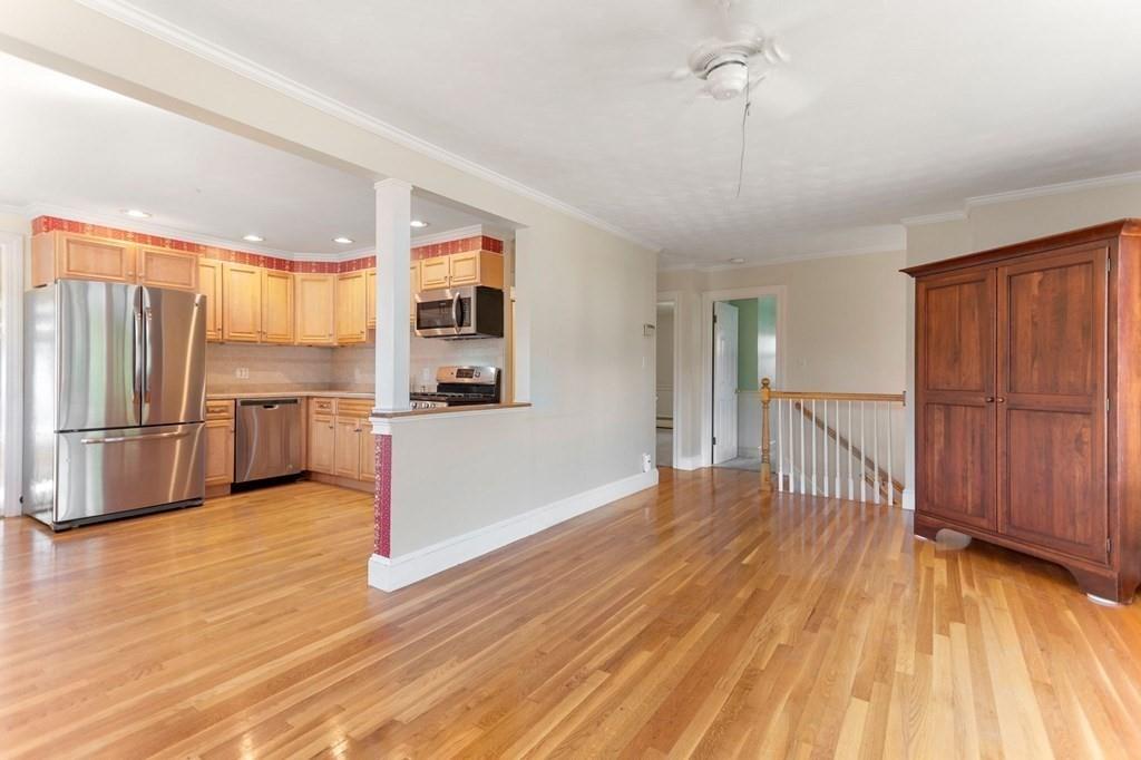 65 Moffatt Road Salem, MA 01970 - Photo 8 of 35 a view of a kitchen with wooden floor electronic appliances and furniture