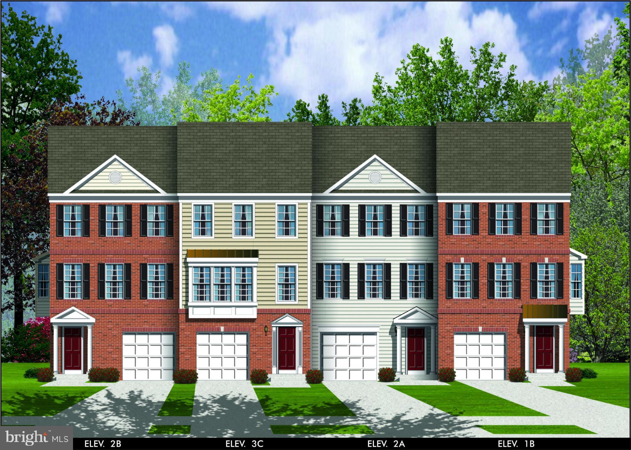 a front view of a residential apartment building with a yard