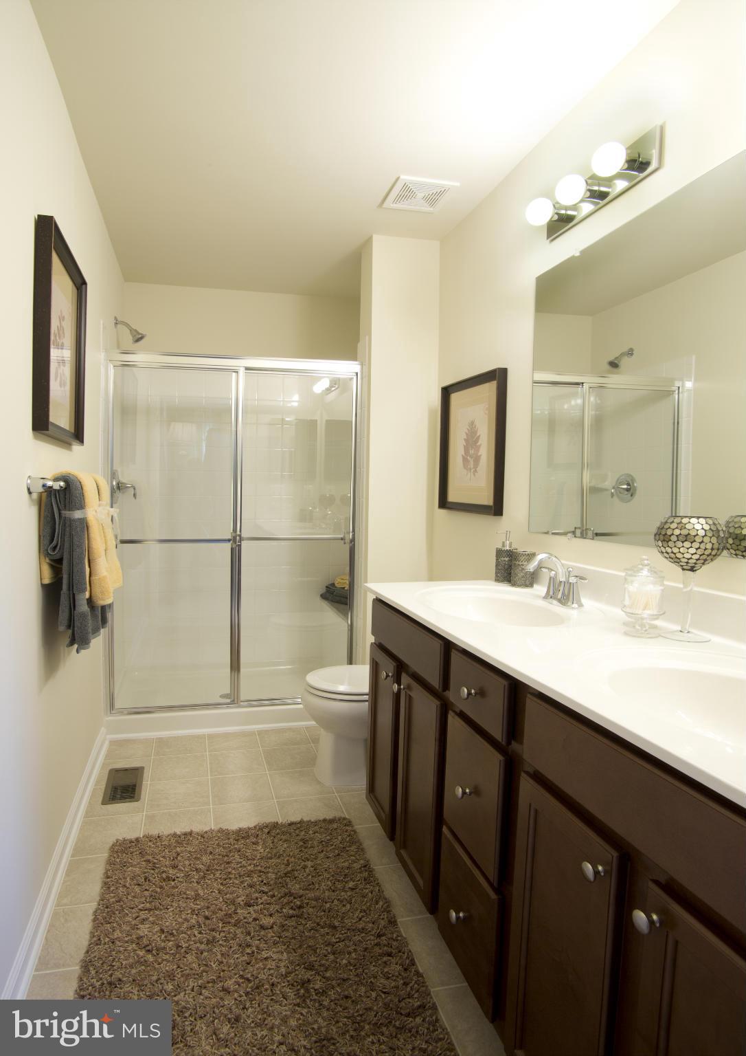 7705 Sentry Terrace Severn, MD 21144 - Photo 11 of 18 a bathroom with a sink a toilet and shower