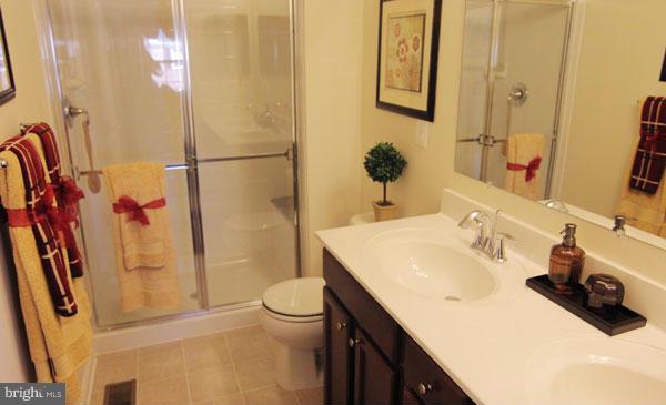 7705 Sentry Terrace Severn, MD 21144 - Photo 14 of 18 a bathroom with a sink toilet and shower