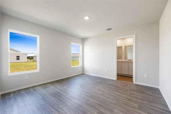 an empty room with wooden floor and a window