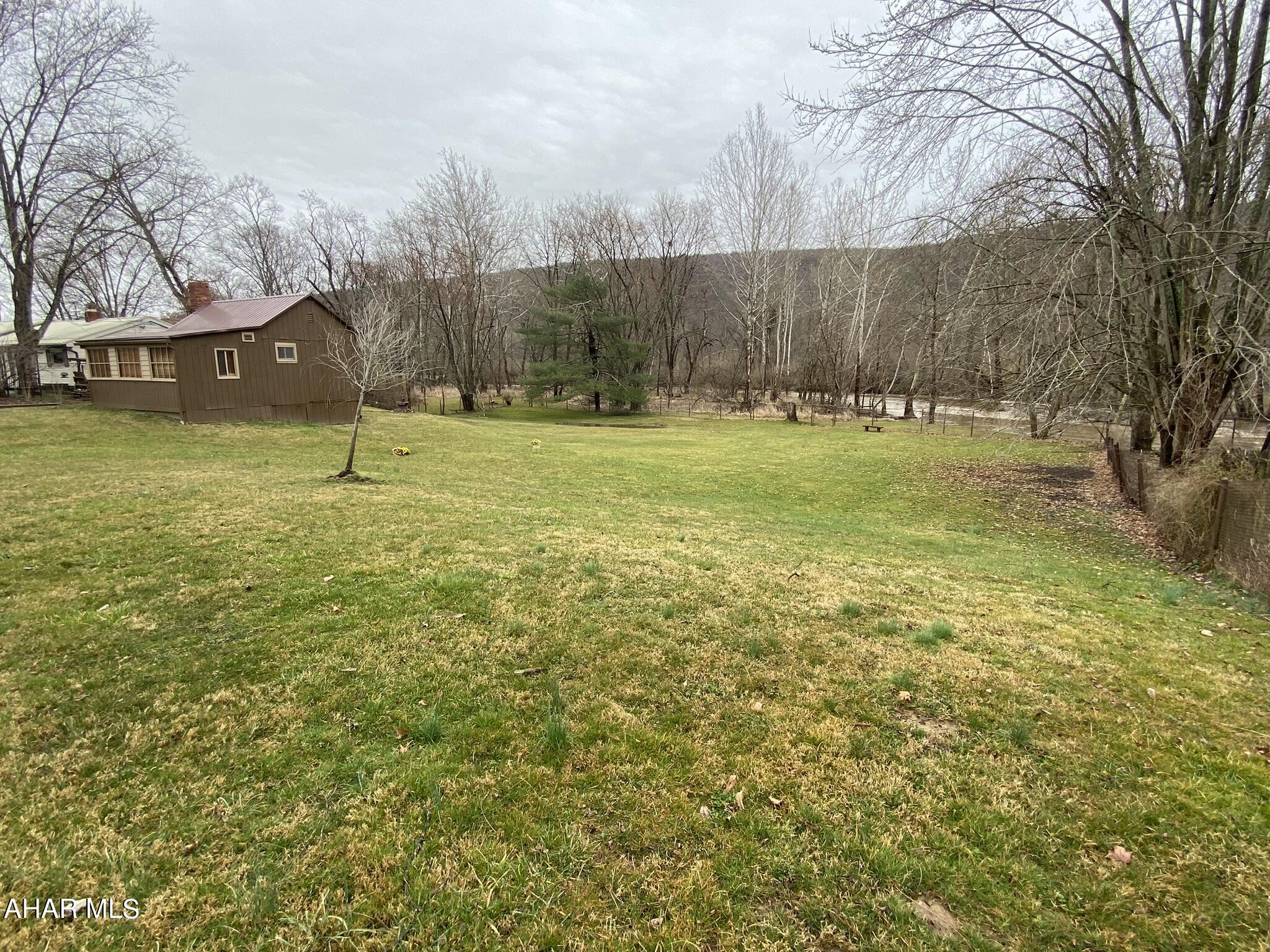 157 Stuckeysville Road Manns Choice, PA 15550 - Photo 21 of 28 a view of outdoor space with deck and trees