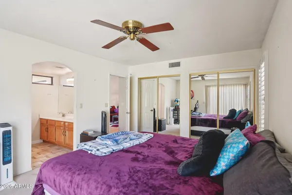 a bedroom with a large bed and a large window