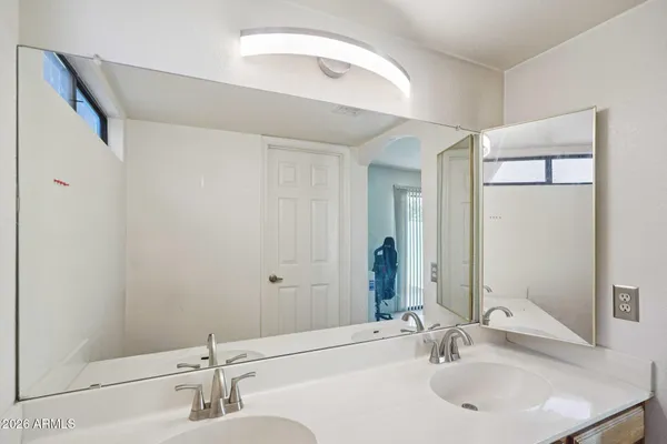 a bathroom with 2 sink and a mirror