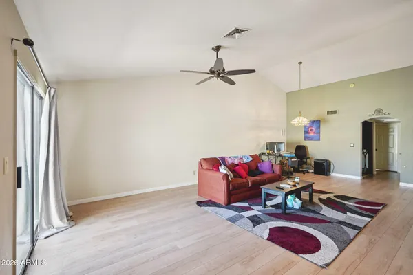 a living room with furniture window and wooden floor