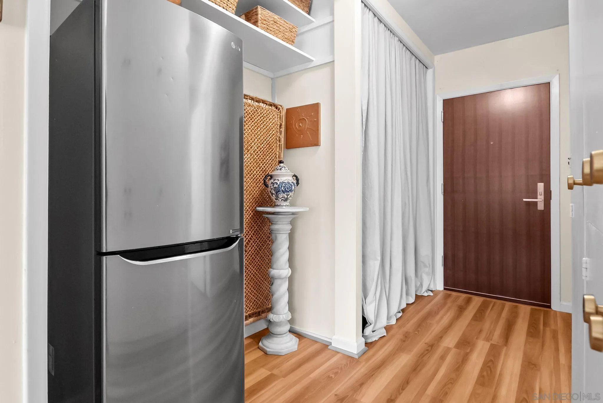 230 Prospect Street, Unit 12 La Jolla, CA 92037 - Photo 11 of 14 a view of empty room with wooden floor and entryway