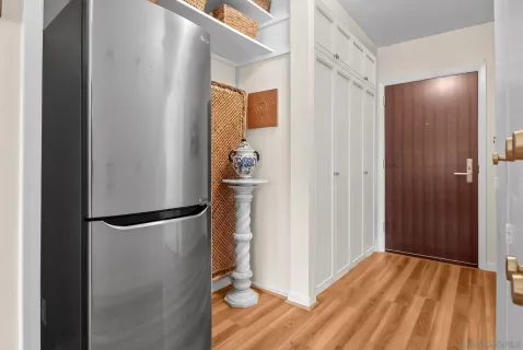 a view of empty room with wooden floor