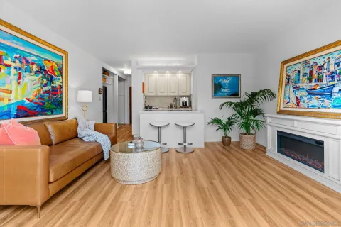 a living room with furniture a piano and a fireplace