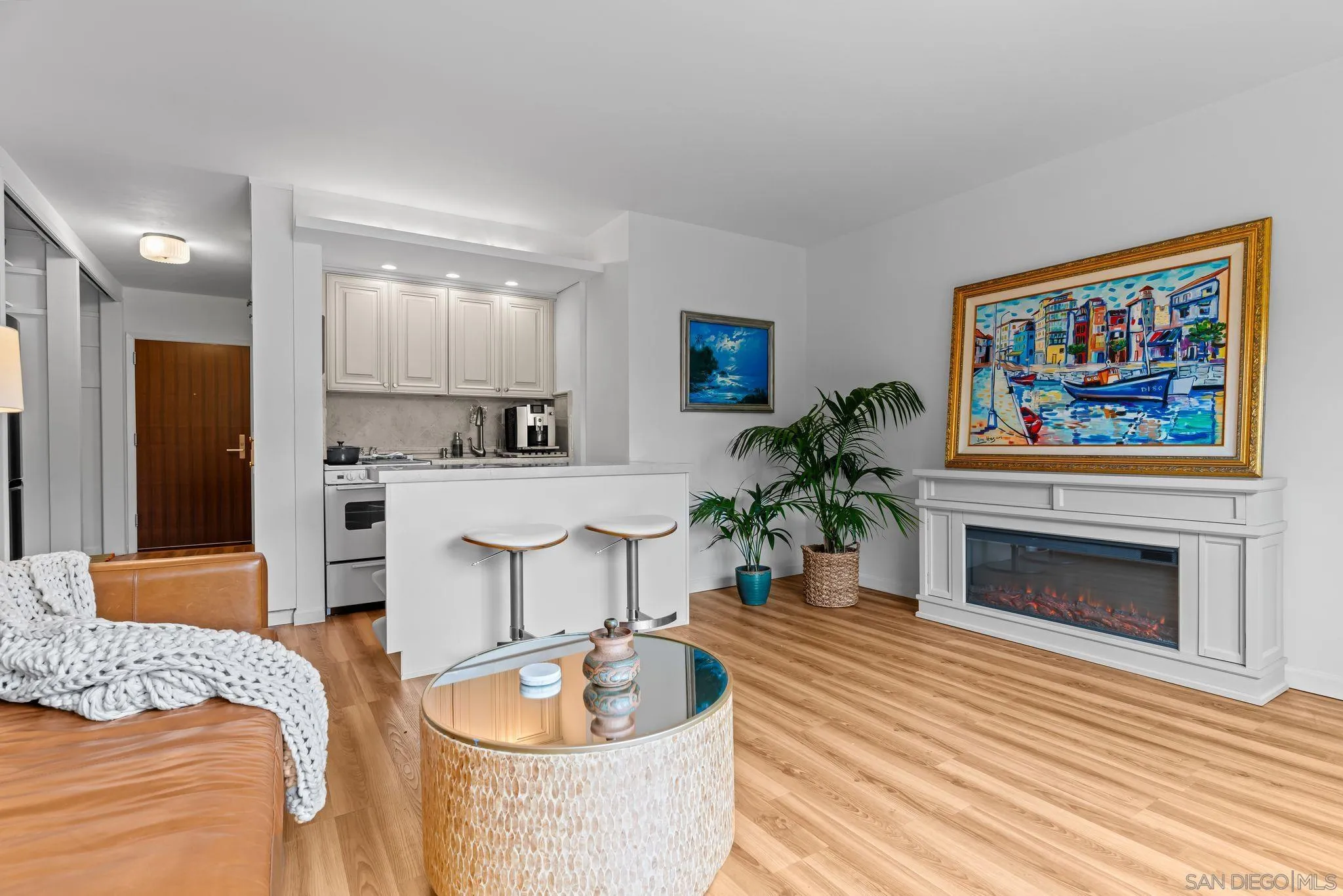 230 Prospect Street, Unit 12 La Jolla, CA 92037 - Photo 7 of 14 a living room with furniture a fireplace and a flat screen tv