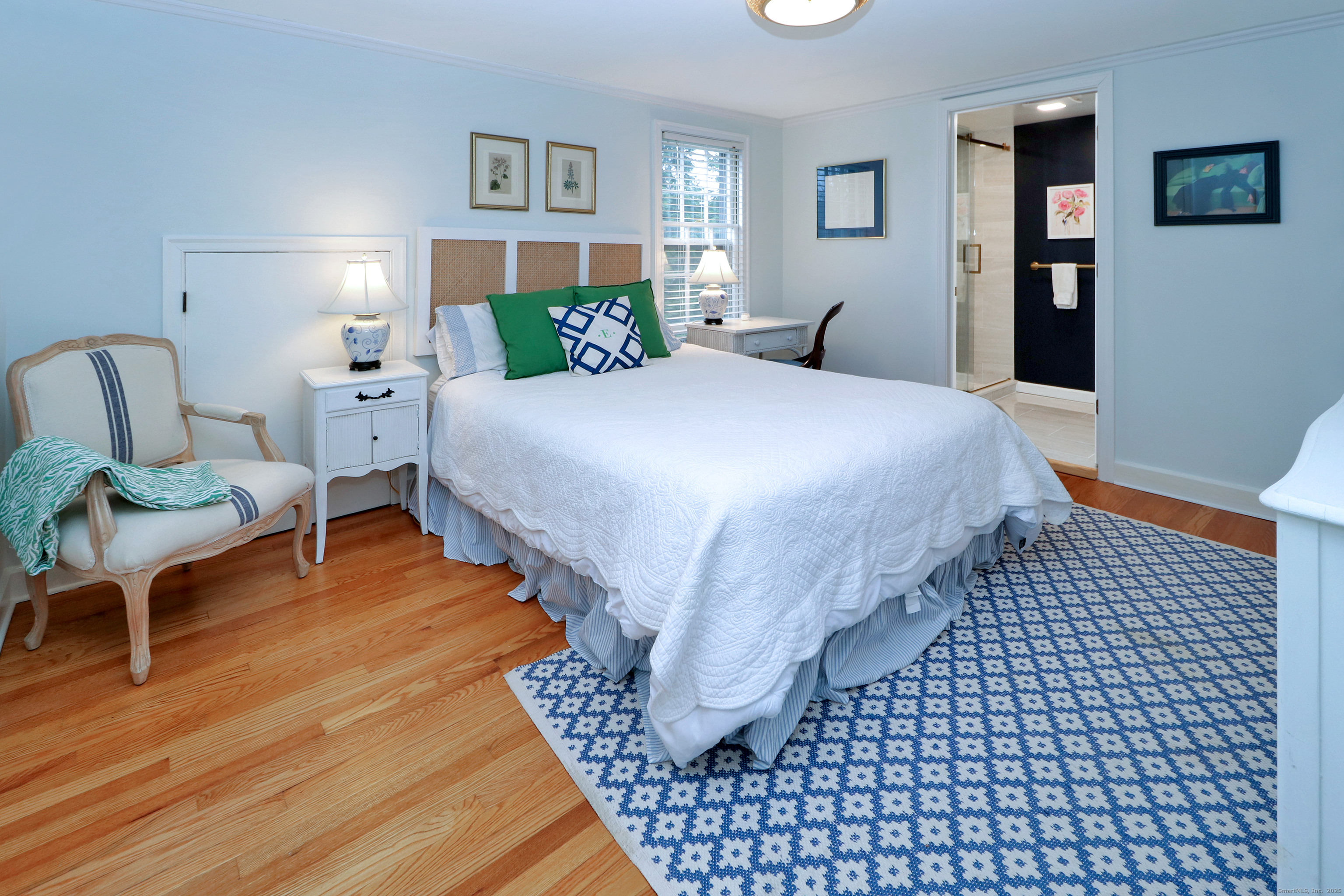 30 Falmouth Road Fairfield, CT 06825 - Photo 20 of 37 a bedroom with a bed and wooden floor