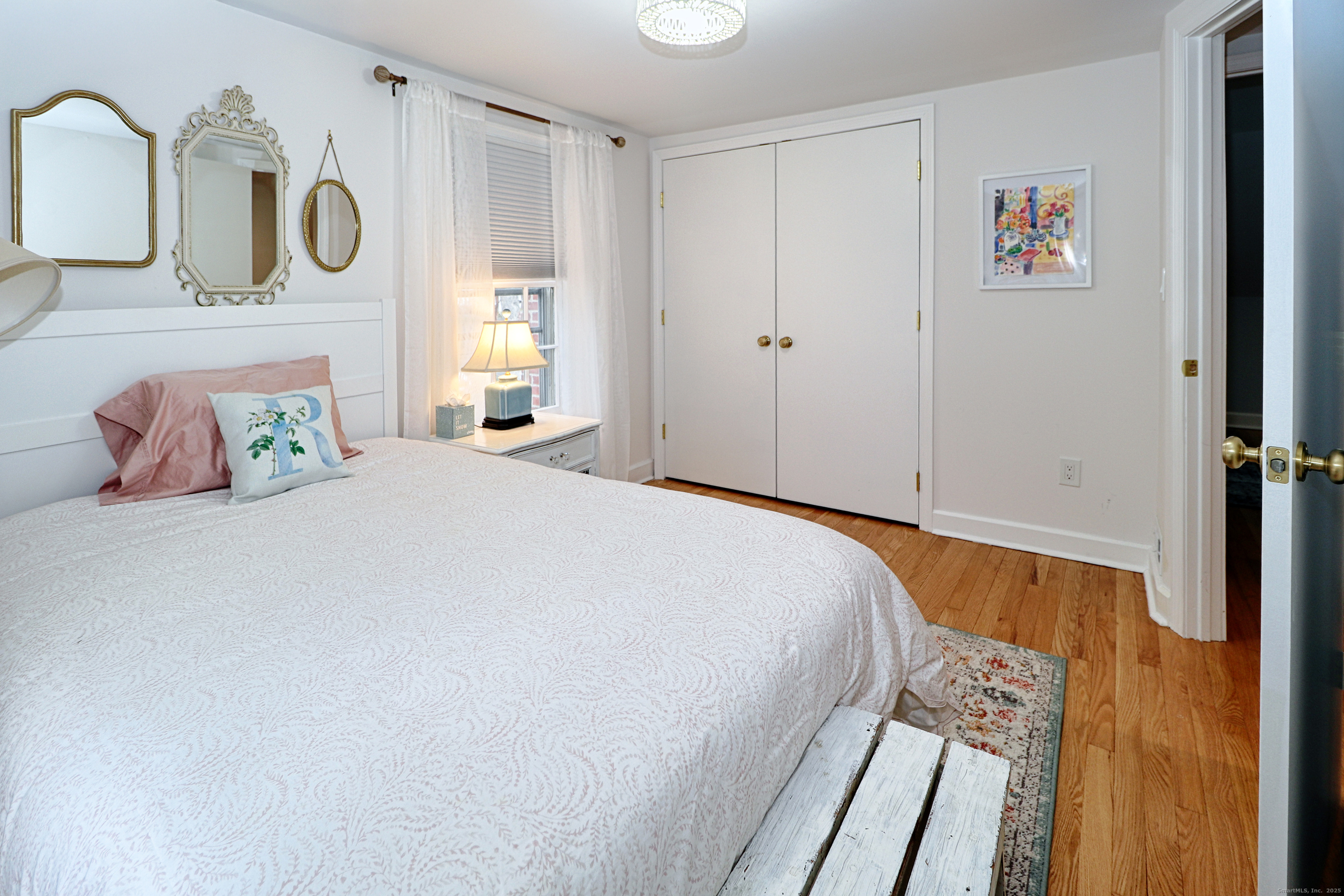 30 Falmouth Road Fairfield, CT 06825 - Photo 25 of 37 a bedroom with a bed and cabinets