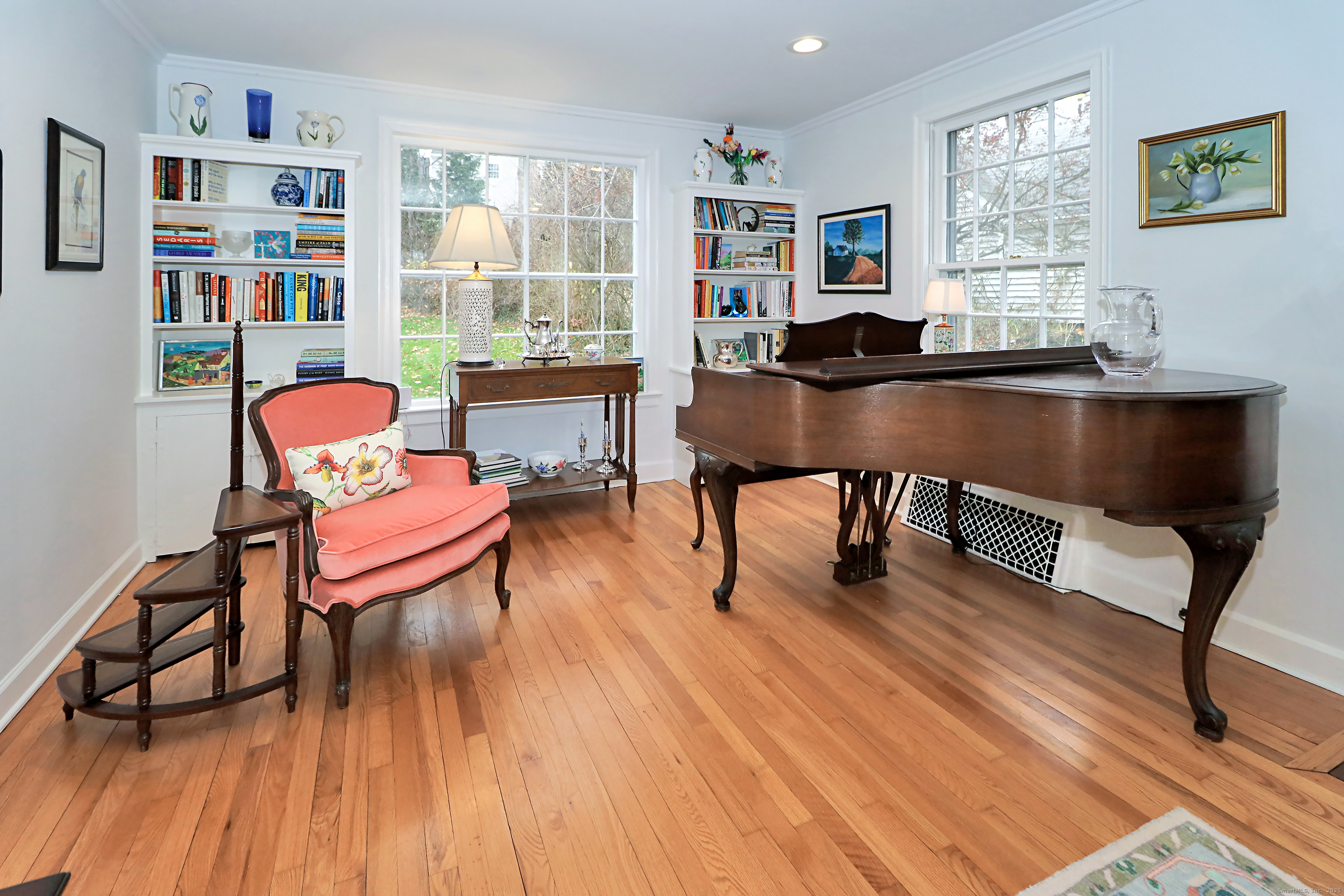 30 Falmouth Road Fairfield, CT 06825 - Photo 7 of 37 a living room with furniture and a book shelf