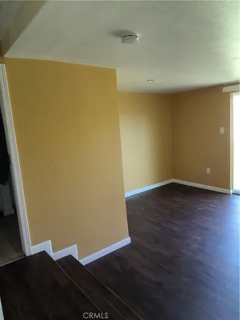 an empty room with wooden floor