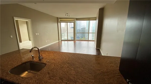 a view of a kitchen with a sink and large window