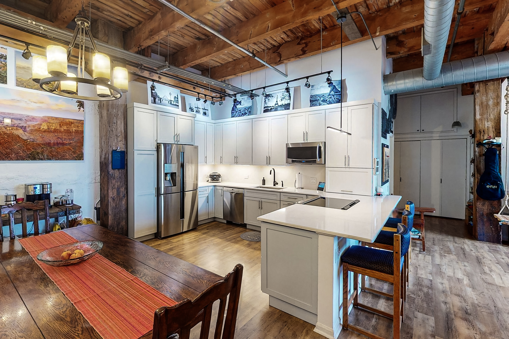 312 North May Street, Unit 3F Chicago, IL 60607 - Photo 2 of 25 a kitchen with a table chairs refrigerator and cabinets