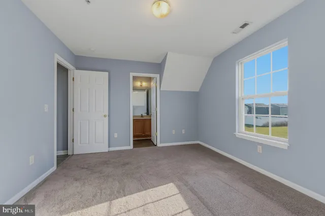 an empty room with windows and closet