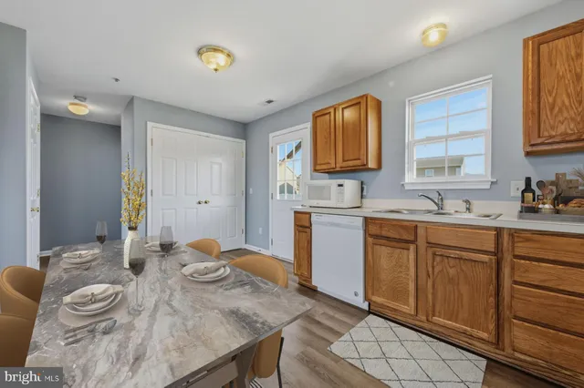 a kitchen with granite countertop a sink cabinets and window