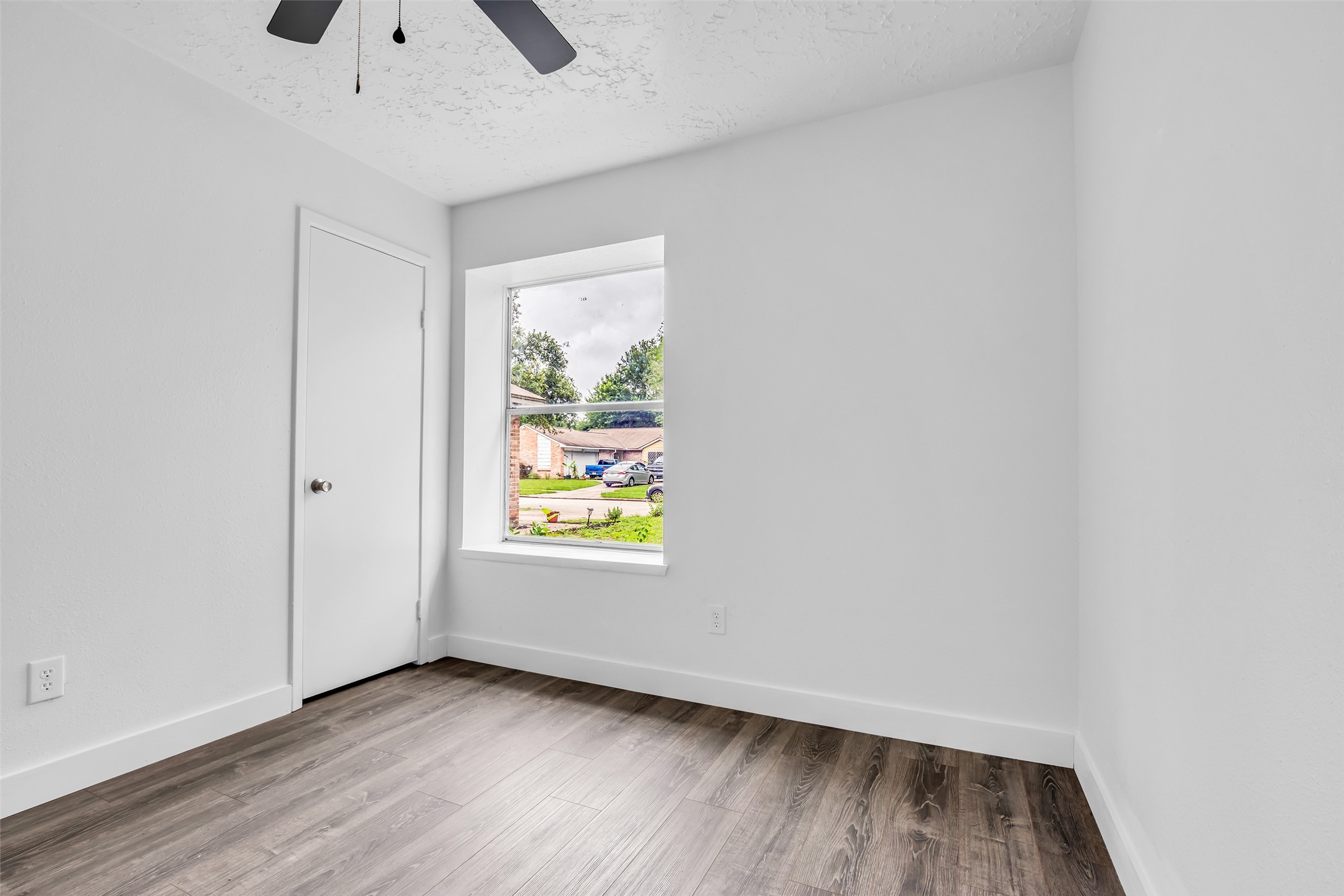 4631 Enchanted Rock Lane Spring, TX 77388 - Photo 9 of 12 A window frames exterior views, illuminating this spacious, ready-to-personalize bedroom.